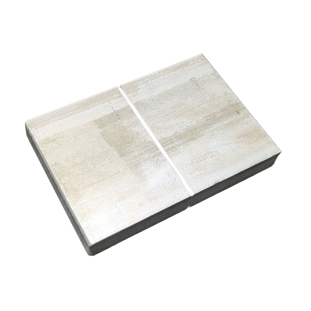 Image of an aluminum test block with a dividing line down the center