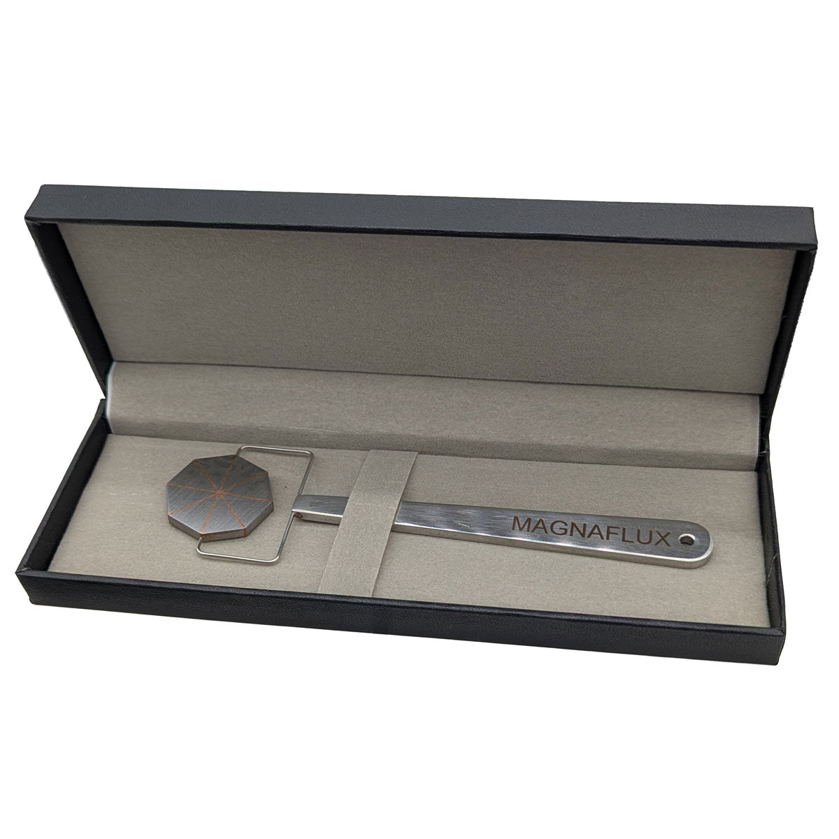 Magnaflux Pie Field Indicator elegantly displayed in a sleek black box, showcasing its unique design for magnetic field detection.