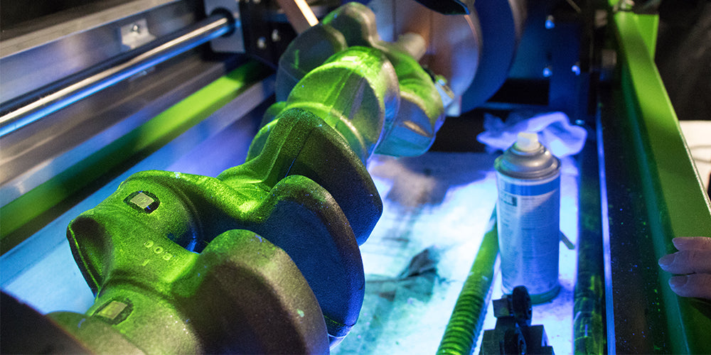 Image of a crankshaft being tested using Magnaflux products
