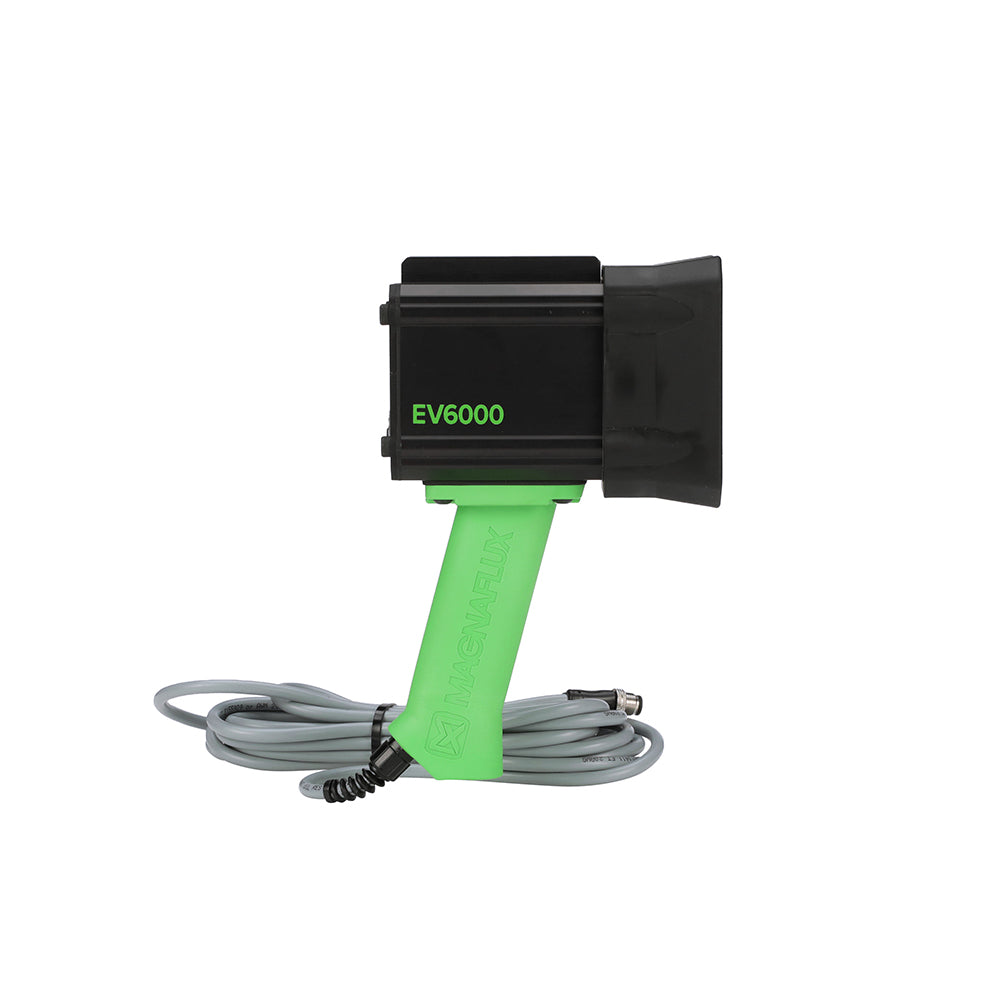 A hand-held Magnaflux EV6000 LED UV black light lamp with a green handle and black body side view.