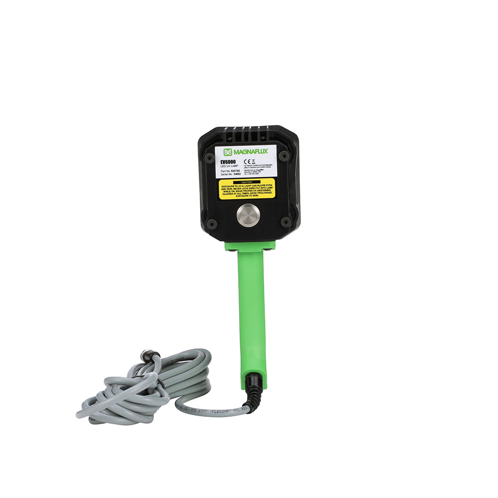 A hand-held Magnaflux EV6000 LED UV black light lamp with a green handle and black body back view.