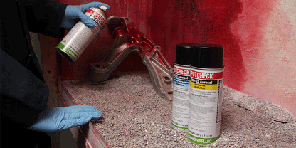 Close-up of Magnaflux Spotcheck Kit contents, including SKL-SP2 penetrant and SKD-S2 developer for effective flaw detection.